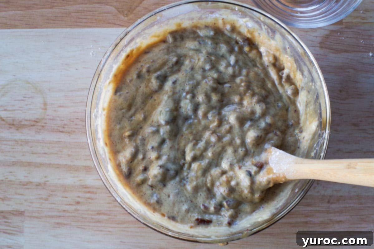 lemon juice added to mixture in a glass bowl with wooden spoon