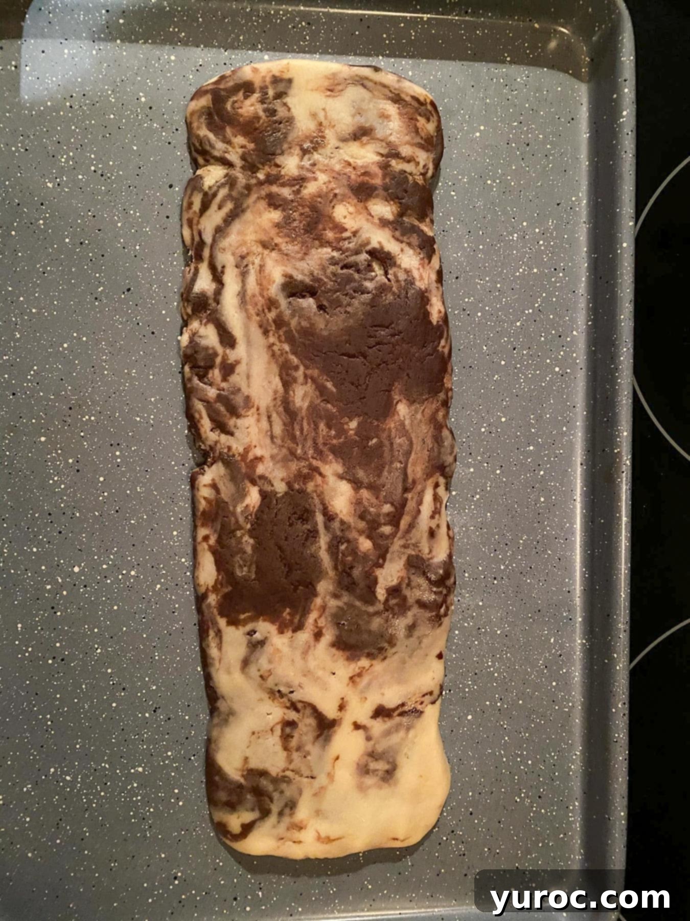 Log of dough on a cookies sheet.