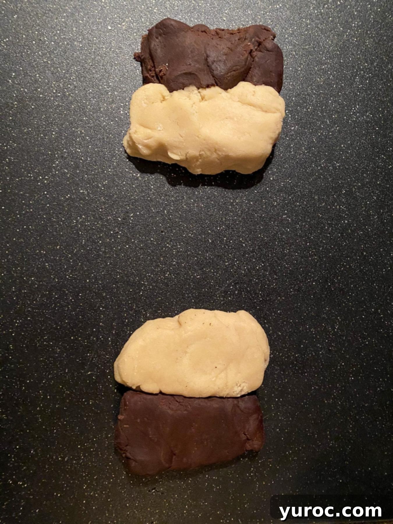 Each dough (vanilla and chocolate) divided in half on a cutting board.