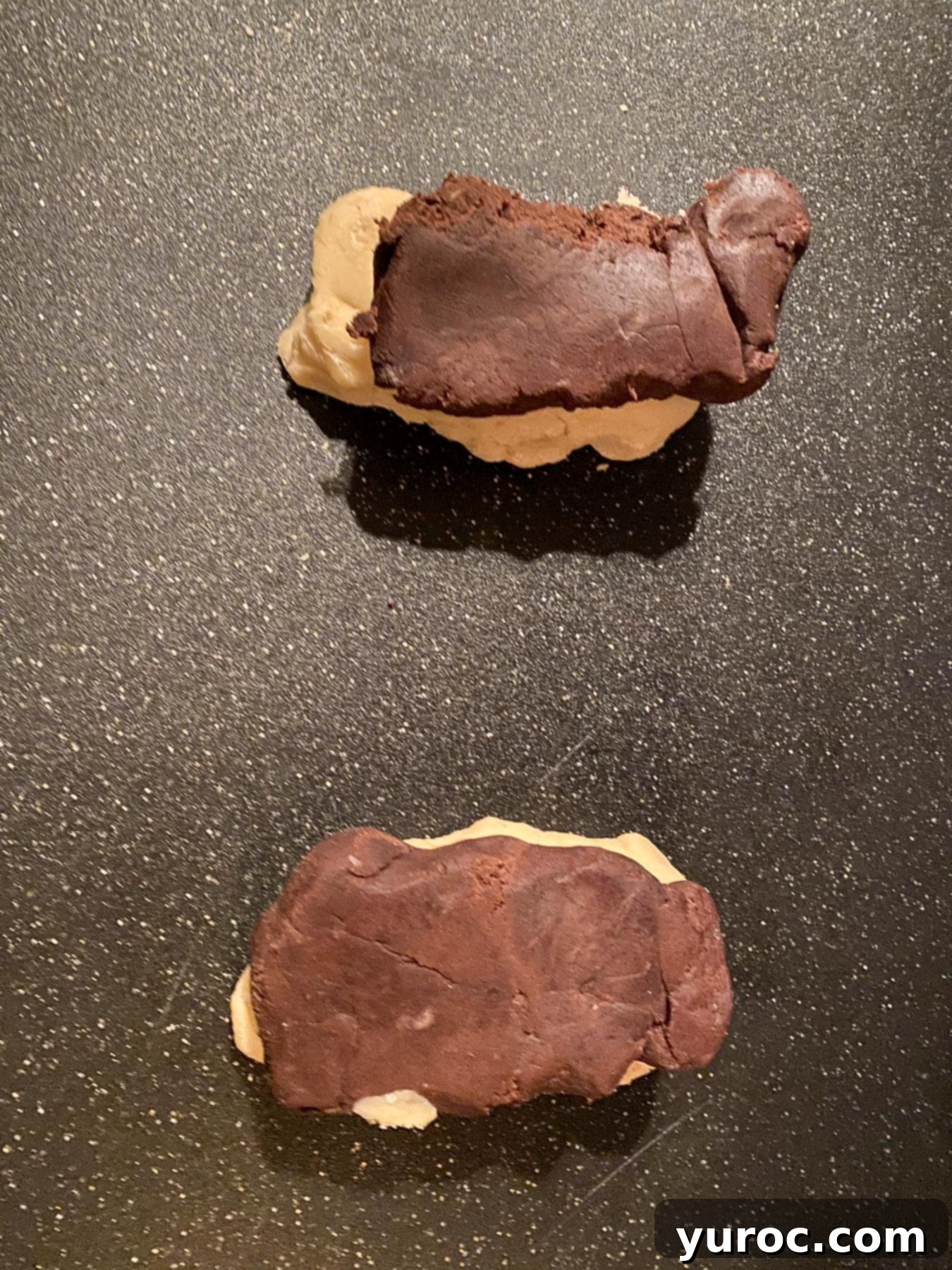 Dough divided in two,, with the chocolate dough on top of the vanilla (white) dough.