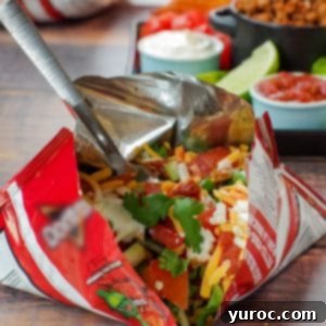 walking tacos in a bag in front and tray of taco meat and fixings in background
