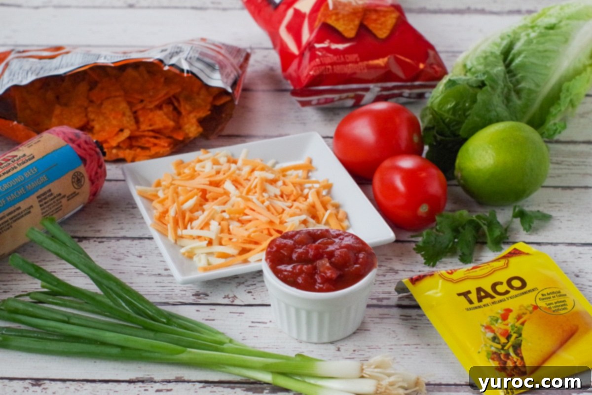 ingredients for walking tacos on a faux white wooden surface