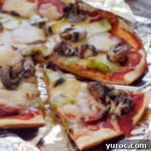 camping pizza on foil, with a slice removed