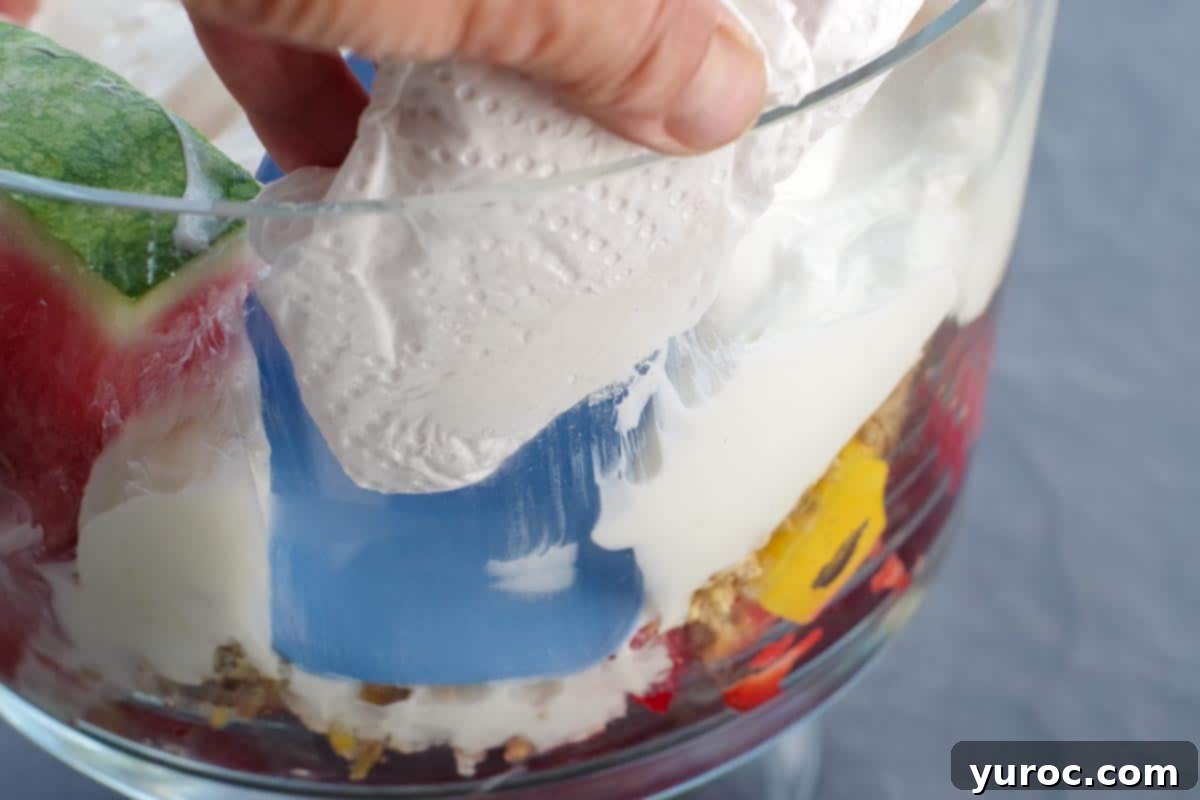Refreshing Watermelon Granola Parfait 11 glass being wiped off with paper towel