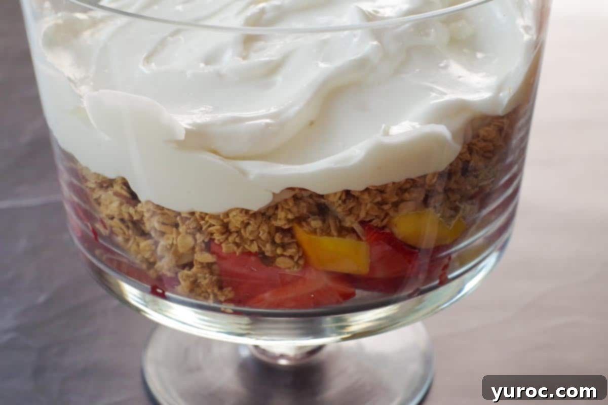 Refreshing Watermelon Granola Parfait 9 granola and yogurt layered over fruit in trifle bowl