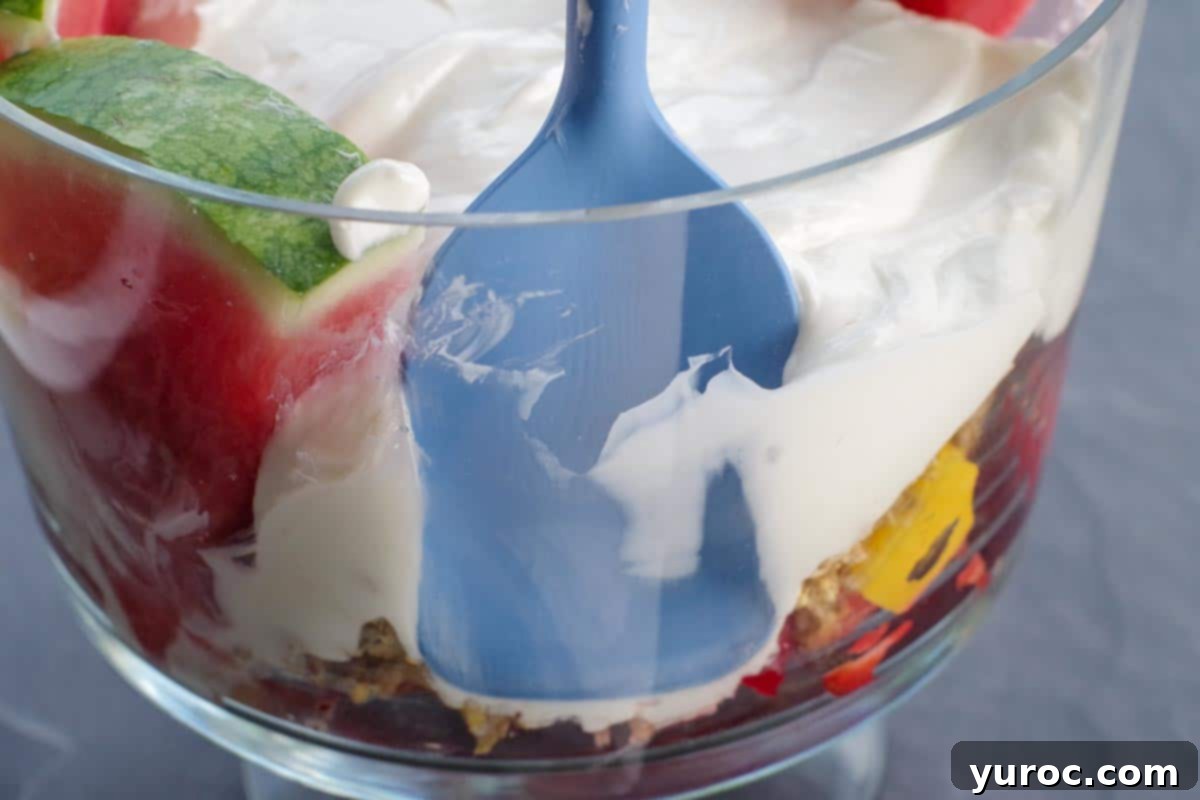 Refreshing Watermelon Granola Parfait 10 spatula pushing back trifle to make room for watermelon