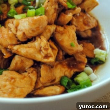 Orange ginger chicken in a white bowl.