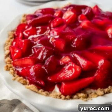 Strawberry cream cheese pie in a white pie dish.