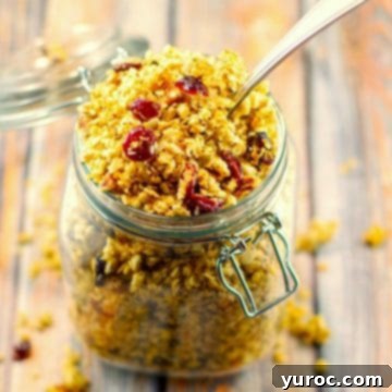 Homemade granola in a jar, with a spoon, shot from above.