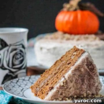 A slice of pumpkin layer cake on a white plate with pumpkin in the background.