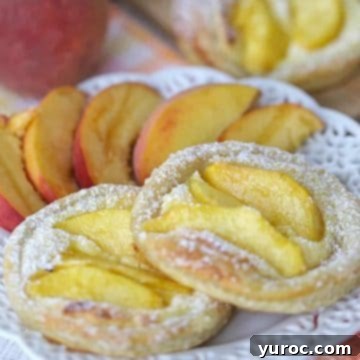 Award-winning peach breakfast danishes on a white lattice plate.