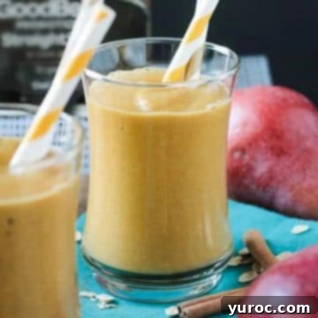 Pumpkin pear smoothies on a blue surface with pears in the background.