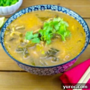 Asian Beef Noodle soup in checkered bowl with chopsticks on a red napkin, on the side